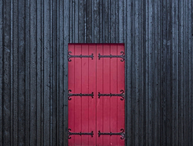 PermaChar® Deep Char timber cladding contrasted by bright red door